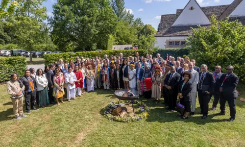 Delegates gather round a fire brazier at the Harmony Summit in Highgrove.