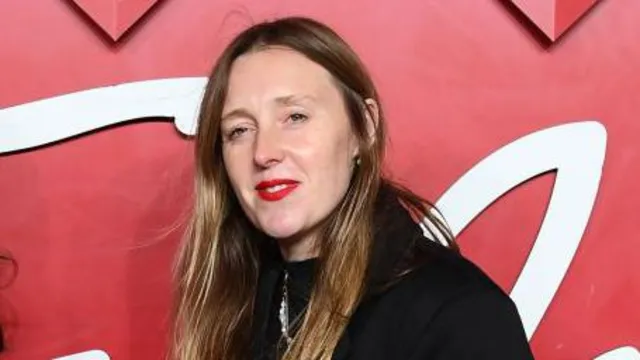 Amy Powney, a fashion designer, speaking at an event.
