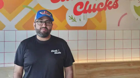 Raza Hashim, CEO of Cluck Clucks, looking at the camera.