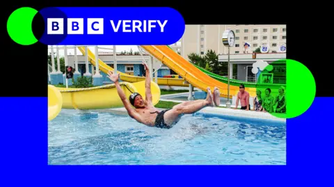 North Korean tourist slides down a waterslide at the new resort
