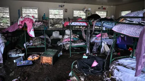 Mud-covered bunk beds at Camp Mystic following the Texas floods
