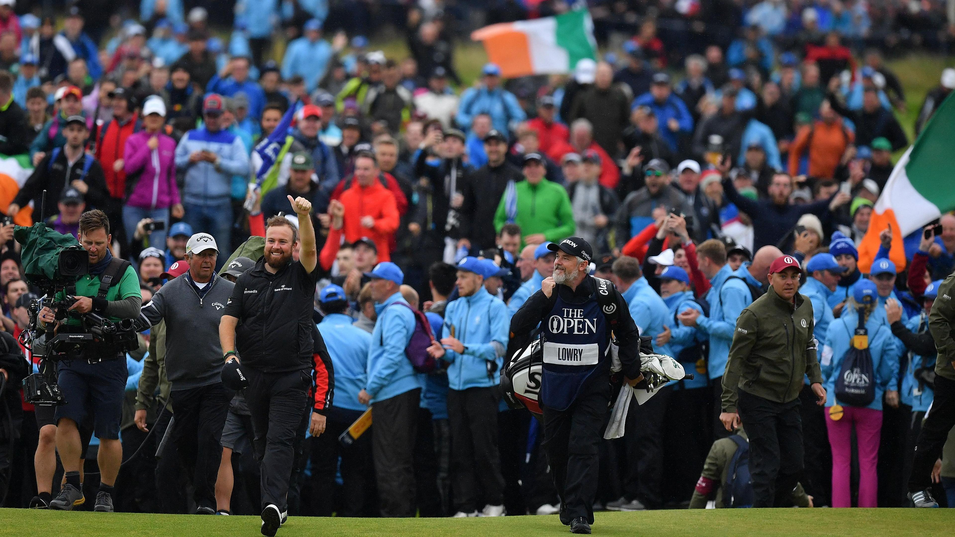 Shane Lowry celebrates on the 18th green at Royal Portrush with his caddie Bo Martin after winning the 2019 Open Championship.