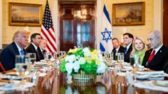 US President Donald Trump (L) and Israeli Prime Minister Benjamin Netanyahu (R) converse during a dinner in the Blue Room of the White House in Washington DC (7 July 2025)