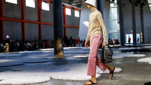 A model showcasing Prada's controversial footwear at Milan Fashion Week.