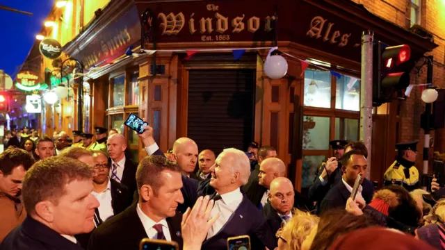 President Joe Biden interacting with a crowd outside a pub in Ireland