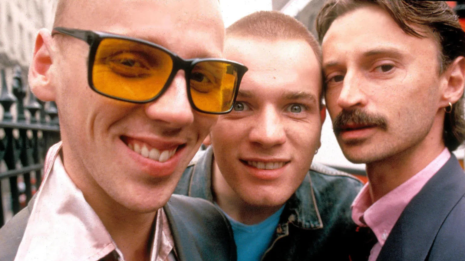 A scene from the Trainspotting film featuring Ewan McGregor, Ewen Bremner, and Robert Carlyle.