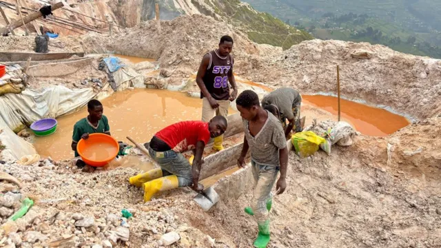 Miners washing coltan ore at Rubaya mine in DR Congo.