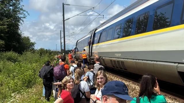 Passengers are seen disembarking a Eurostar train in France following a four-hour delay.
