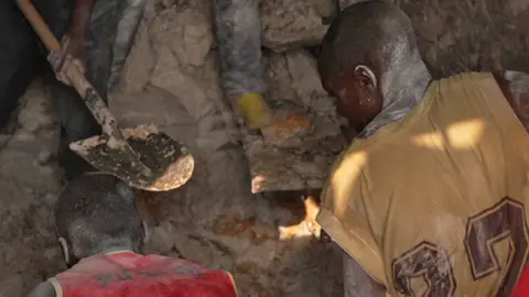 Miners dig in a pit at Rubaya mine in eastern DR Congo.
