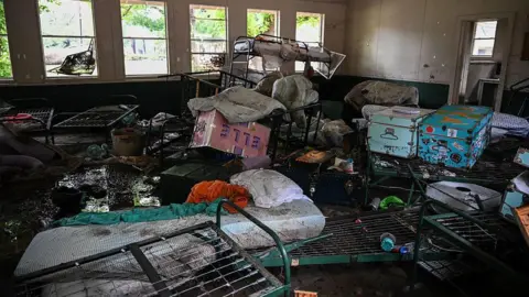 Scattered personal belongings at Camp Mystic