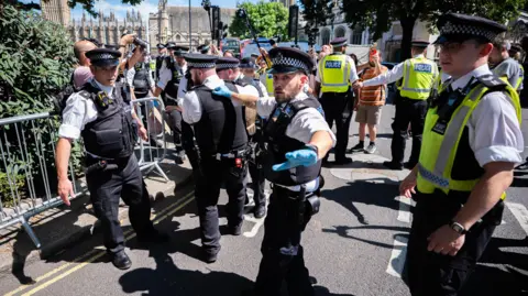Police officers at a protest in London where activists were arrested.