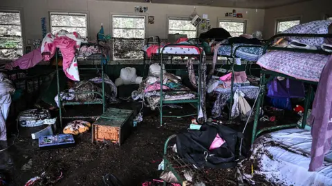 Muddied bunk beds at Camp Mystic after the flood