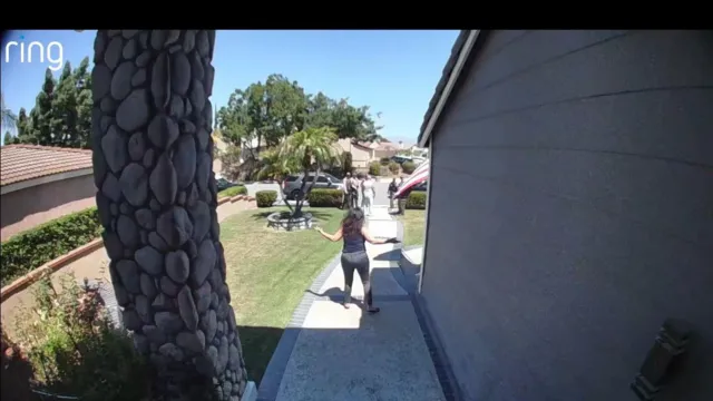 A RING camera captures a woman, presumably Arpineh Masihi, standing outside a suburban home in Los Angeles County, facing federal agents.