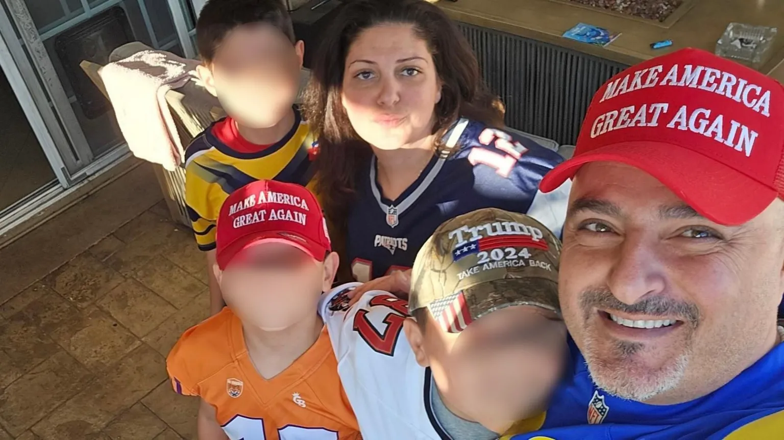 Arpineh Masihi and her family, including her husband Arthur Sahakyan and their four children, pose for a photo. Several family members, including two young boys, wear MAGA/Trump hats.