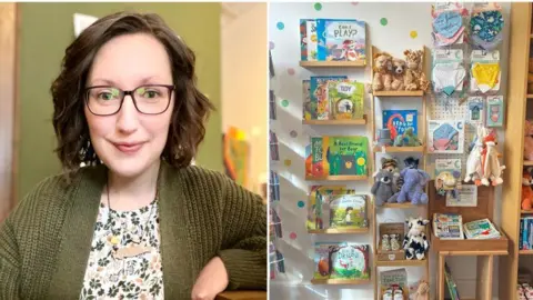 Erica Stahl, a woman with a warm demeanor, is captured inside the shop, surrounded by a charming collection of soft toys, books, and baby essentials, reflecting the store’s inviting ambiance.