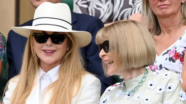 Nicole Kidman and Anna Wintour smile as they sit next to one another at Wimbledon.