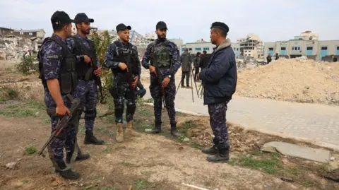 Hamas-run security forces stood beside destroyed buildings at the Arafat Police Academy in Gaza City during a ceasefire with Israel in January.
