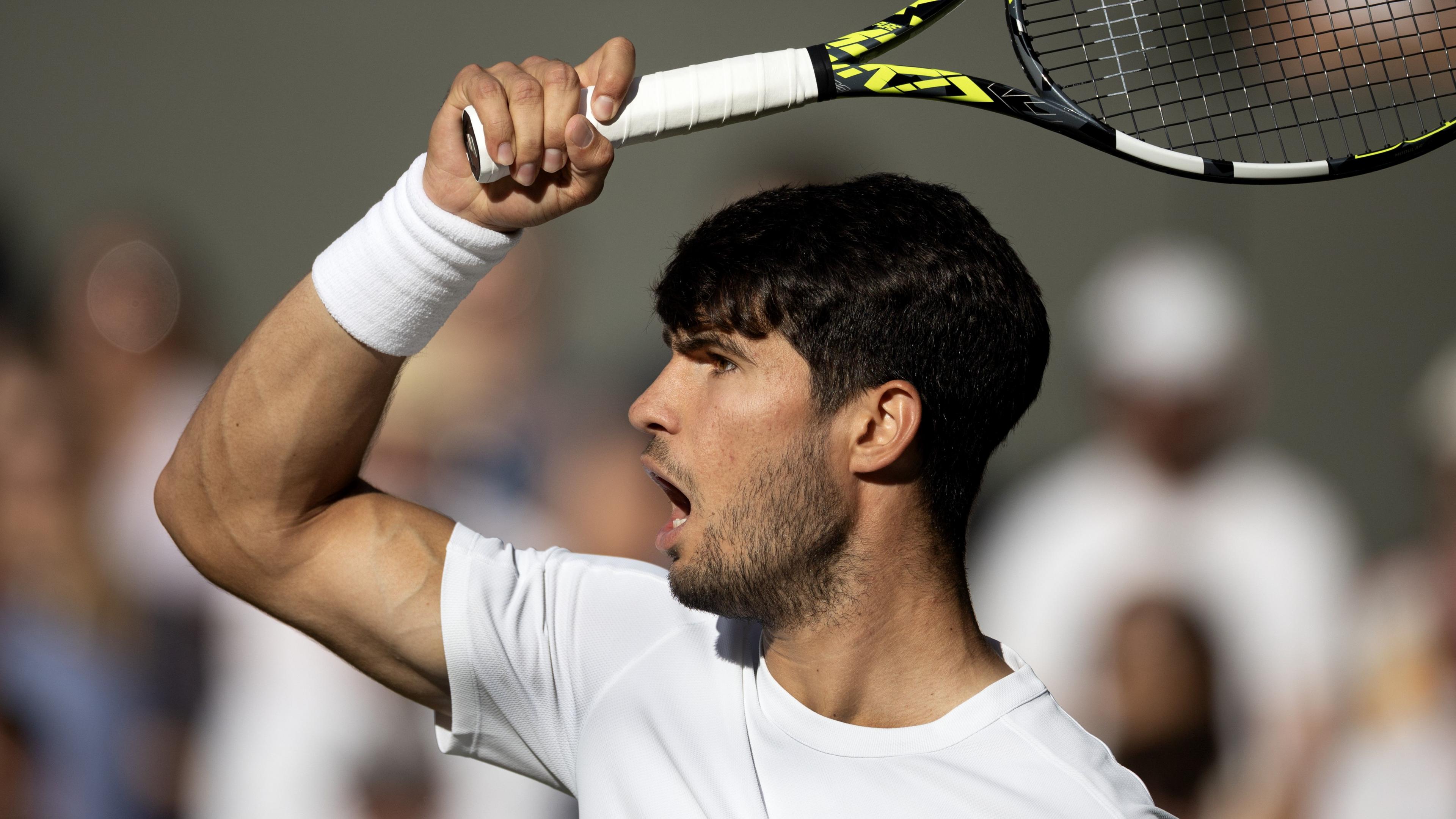Carlos Alcaraz hits a forehand during a match.