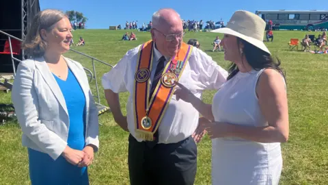 Fleur Anderson (left) and Emma-Little Pengelly were seen with the Orange Order's grand secretary, the Reverend Mervyn Gibson.