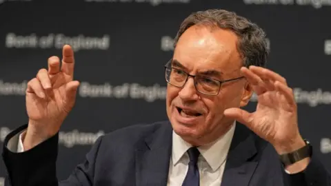 Bank of England Governor, Andrew Bailey gestures while speaking at a meeting in July.